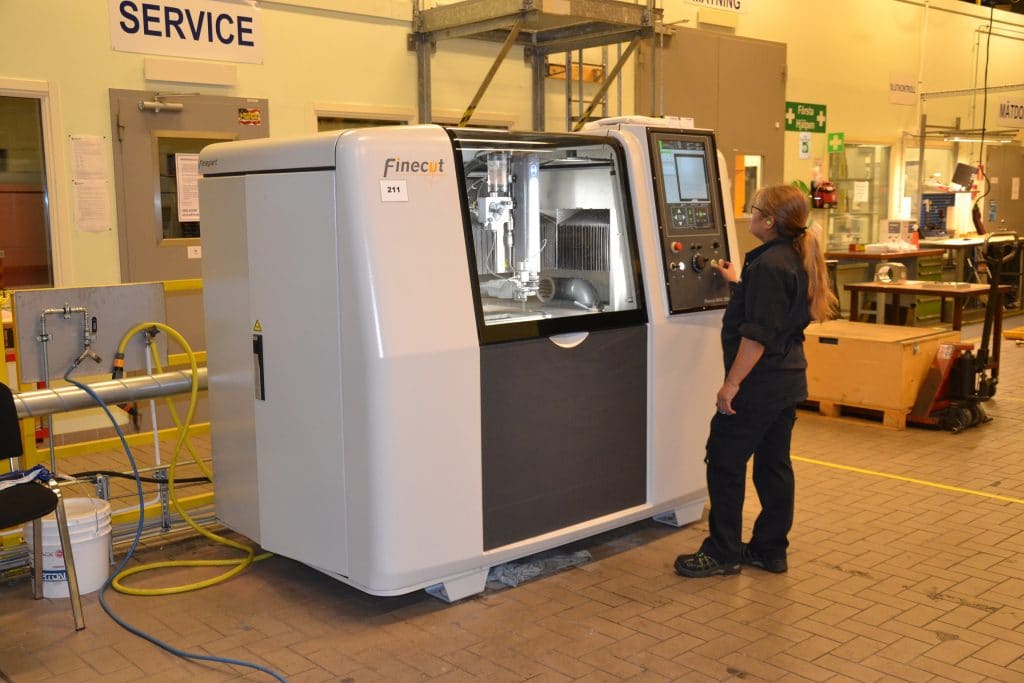 Operator at Brogren Industries running the Finecut WMC500II