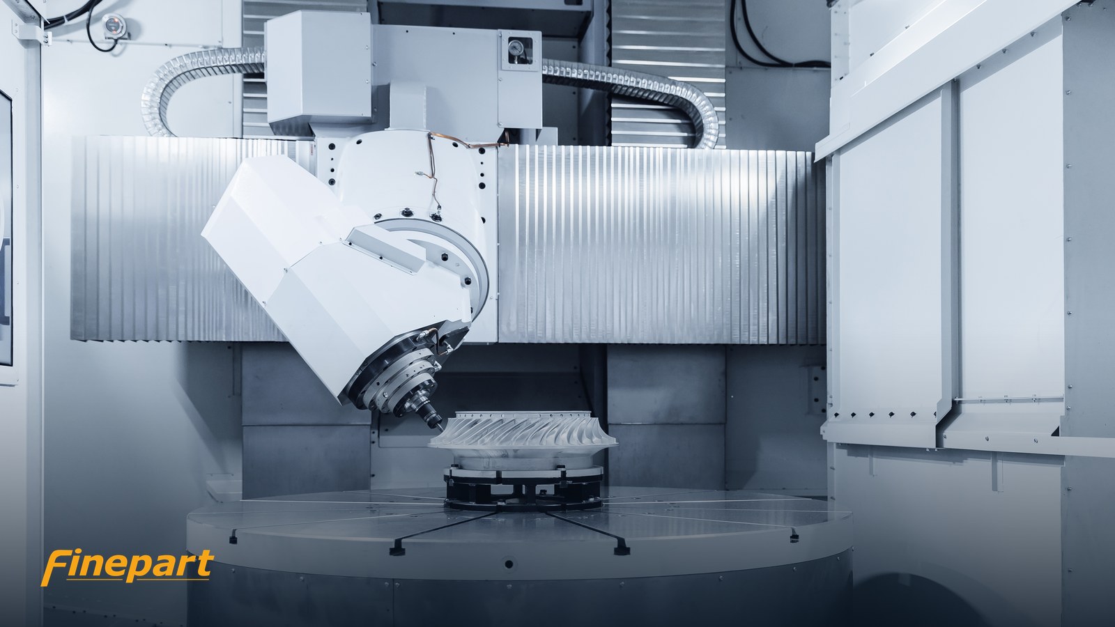 CNC machining center cutting a precision metal part with a rotating tool